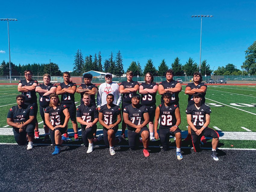 Offensive line coach Brian Foote poses with the 2022 Yelm High School offensive line.