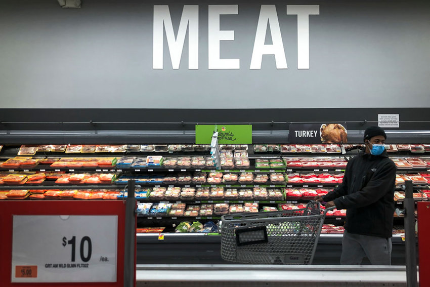 A man shops in the meat section at a grocery store in Washington, D.C., on April 28, 2020. (Drew Angerer/Getty Images/TNS)