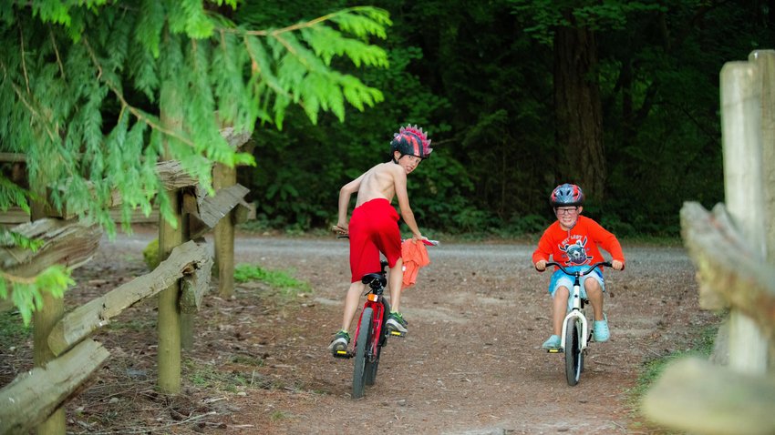 Children peddle their bikes around trails at Millersylvania State Park in 2022.