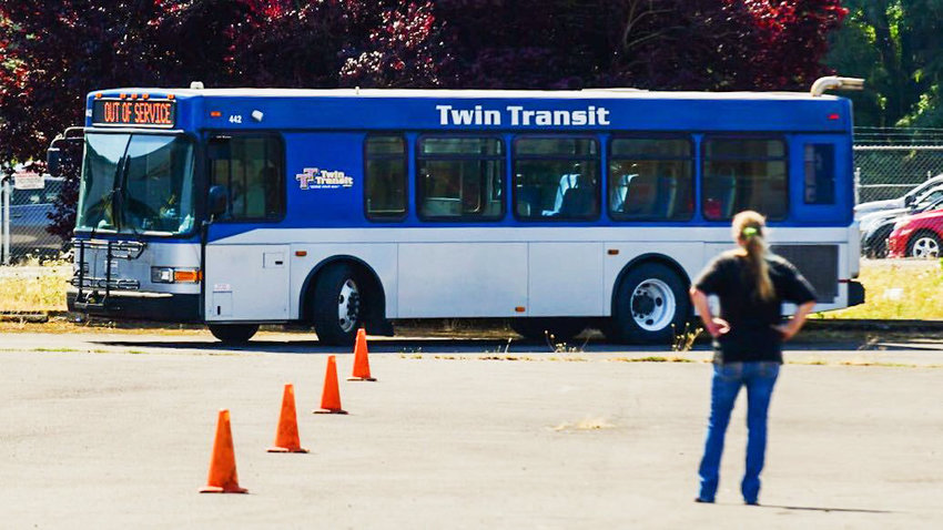 A Twin Transit bus drives around cones in a Centralia parking lot on Wednesday.