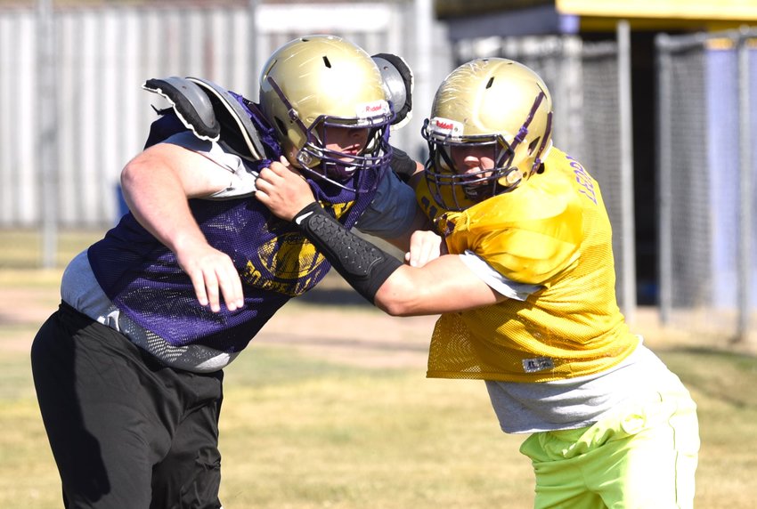 Rylan McGraw (right) gets his hands onto Tommy Hornsby III (left) during a drill at Onalaska&rsquo;s Aug. 23 practice.
