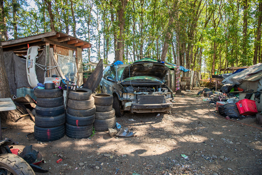 Tires, vehicles and structures span across land at the end of Eckerson Road in Centralia in this September file photo.