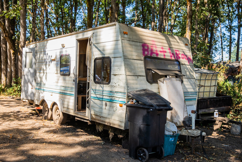 A dilapidated trailer reads &ldquo;Bathroom&rdquo; in spray paint at a homeless encampment at the end of Eckerson Road in Centralia earlier this year.