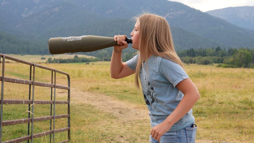 Ella Lees blows into a bugle tube to replicate the call of a bull elk.