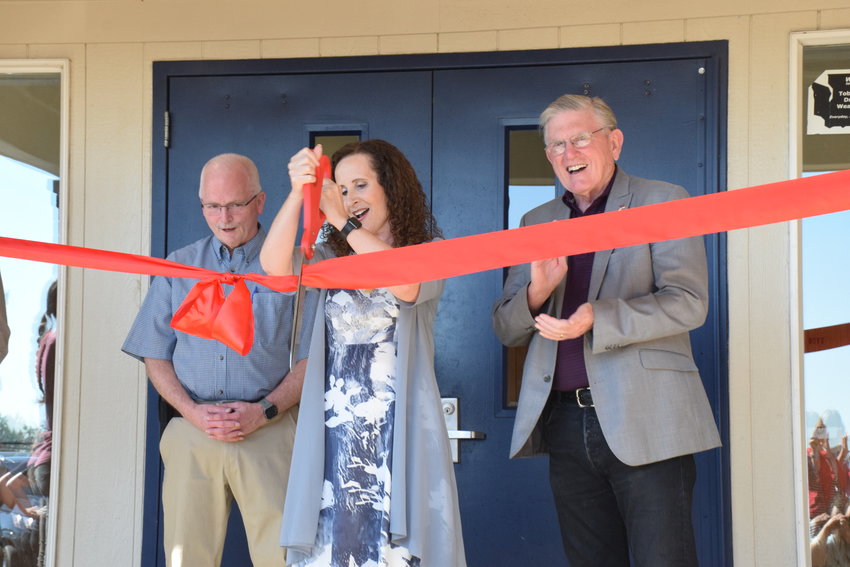 Cornerstone Christian Academy Superintendent Sandra Yager, center, cuts the ribbon on the school&rsquo;s new Battle Ground campus, flanked by Battle Ground Mayor Philip Johnson, left, and school board chair Bill Gibbons, right, at a ceremony on Sept. 1.