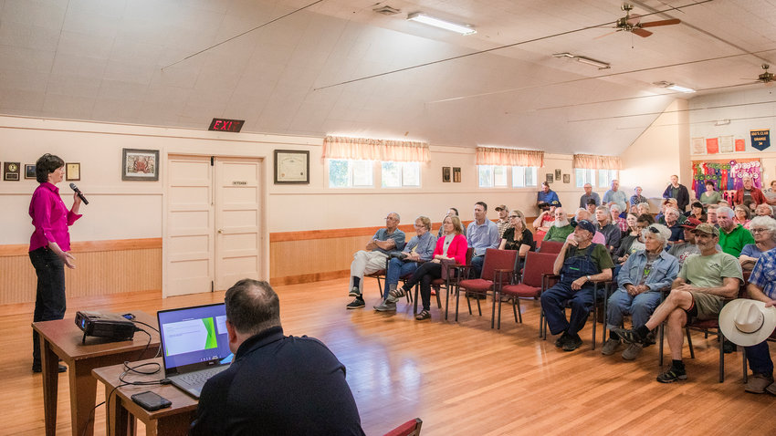 Lewis County Commissioner Lindsey Pollock presents on potential county code change that would allow for research on windmills to a packed Baw Faw Grange earlier this month.
