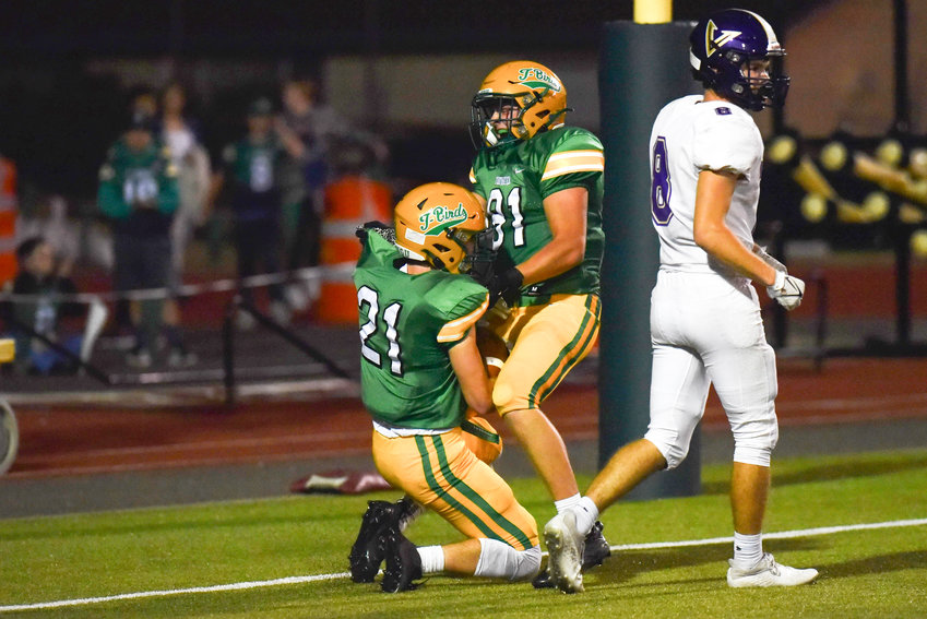 Beckett Wall (81) celebrates with Derek Thompson (21) following the latter's touchdown reception late in the first half of Tumwater's 8-6 win over North Kitsap on Sept. 9.