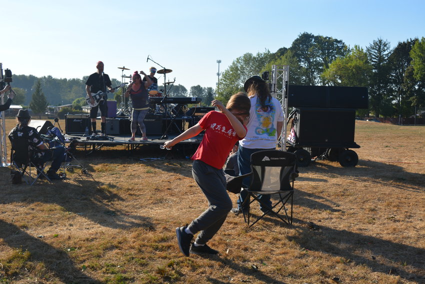 A fan dances as Filthy Rags plays at the Extreme Tour at Kiwanis Park on Sept. 9.