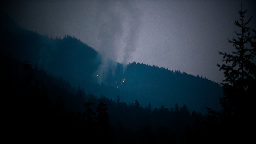 Smoke columns rise from a short run of flames seen from U.S. Highway 12 near Packwood in this file photo.