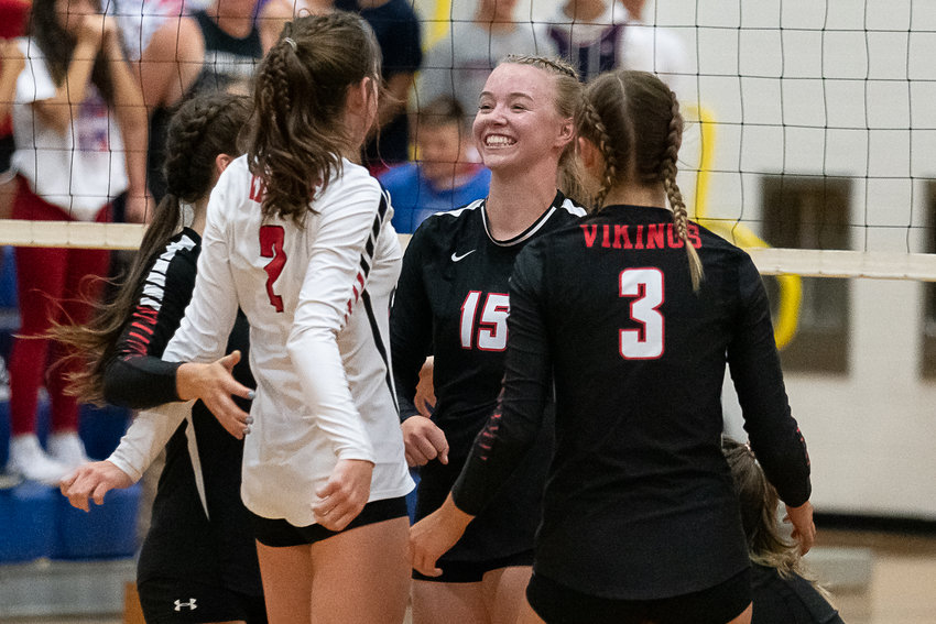 Mossyrock's Hailey Brooks (15) smiles with her team after coming back from a two set deficit to defeat Adna on the road Sept. 12.
