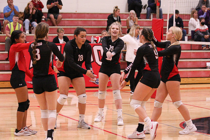 The Tenino volleyball team celebrates after a point against Toledo Sept. 13.