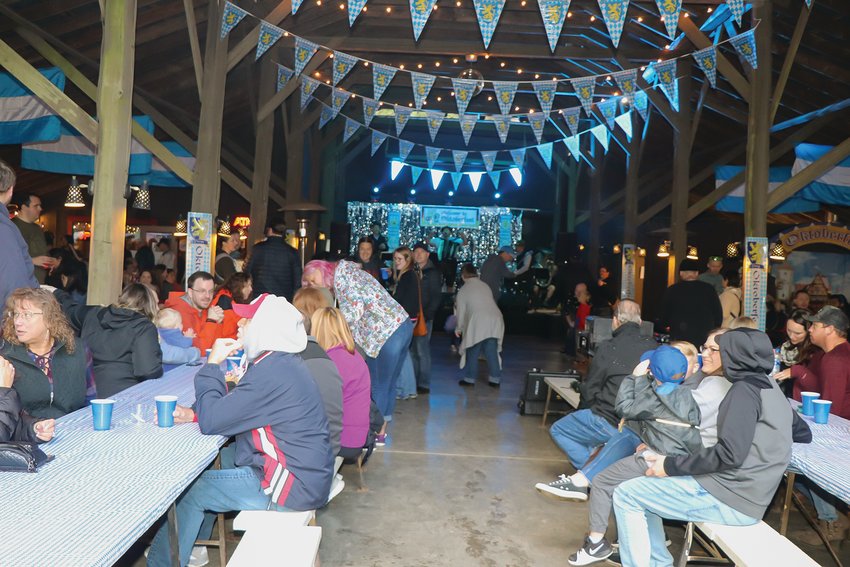 Families eat and drink at a previous Oktoberfest as the Smilin&rsquo; Scandinavians play.