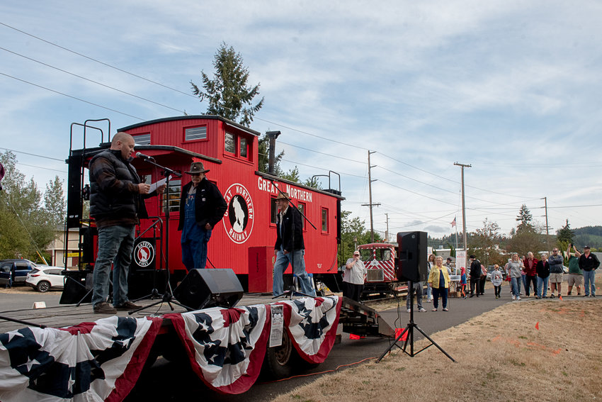 Tenino Mayor Wayne Fournier introduces Don Bowman of Olympia and Jan Wigley of Centralia at the ribbon cutting ceremony to open the restored caboose at the Tenino Depot Museum on Saturday morning. Photo by Owen Sexton.