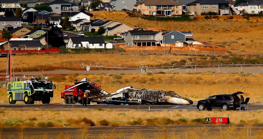 The charred remains of a privately owned small jet rests on a runway surrounded by emergency vehicles Tuesday morning at the Tri-Cities Airport in Pasco. Passengers escaped before the plane burst into flames. Bob Brawdy