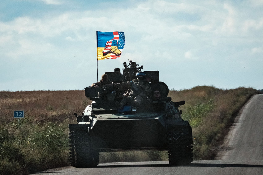 A Ukrainian tank rides with a flag picturing Ukraine and U.S. flags shaking hands in Novostepanivka, Kharkiv region, on September 19, 2022, amid the Russian invasion of Ukraine. (Yasuyoshi Chiba/AFP via Getty Images/TNS)