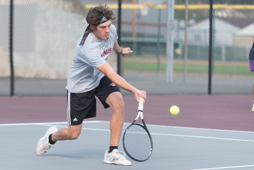 Aaron Boggess charges in to send the ball back over the net during his singles match against Aberdeen on Sept. 21.