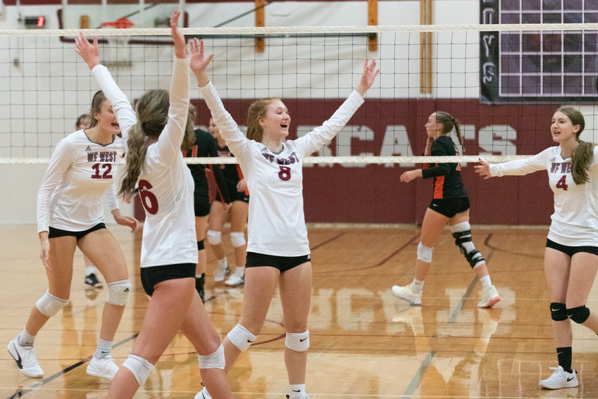 Chloe Chloupek (8) and the W.F. West volleyball team celebrate a point during their five-set win over Centralia on Sept. 22.
