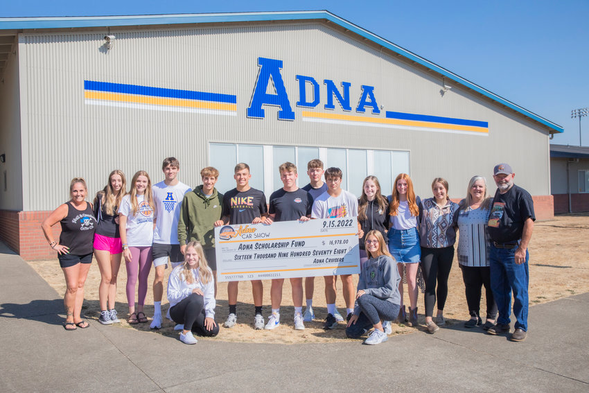 Angie Humphrey and Jim Smith present a check for $16,978 to the Adna Scholarship Committee Monday afternoon. Adna Grocery routinely holds fundraisers for Adna scholarships, including the Adna Car Show Camp and Cruise. Smith is the owner of Adna Grocery.