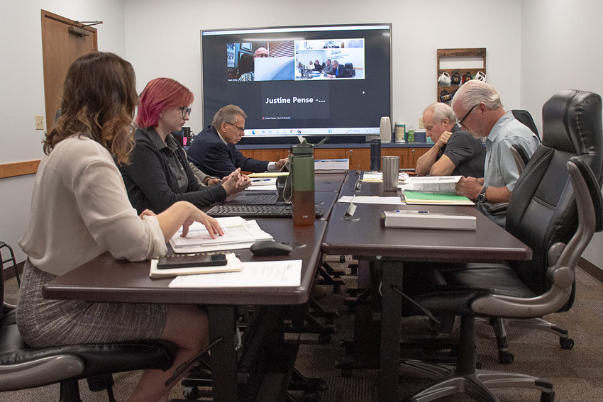 Port of Chehalis CEO Lindsey Senter, left, walks commissioners Mark Anders, Paul Ericson, right, and Mark Giffey, who attended remotely via Zoom, through the two fiscal year 2023 draft budget proposals.