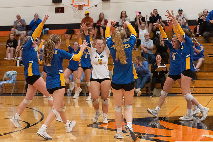 The Adna volleyball team celebrates a block during its sweep at Napavine on Sept. 27.