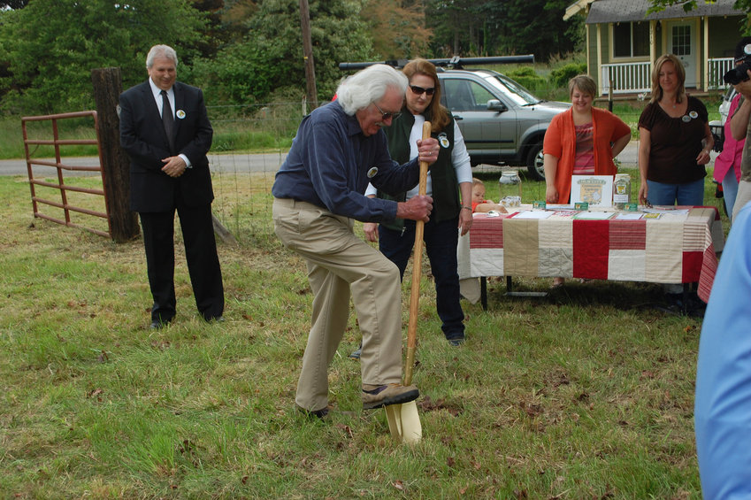FILE PHOTO &mdash; Former mayor Bill Moeller digs the first shovel into the Hub City Community Garden  in this Chronicle file photo.