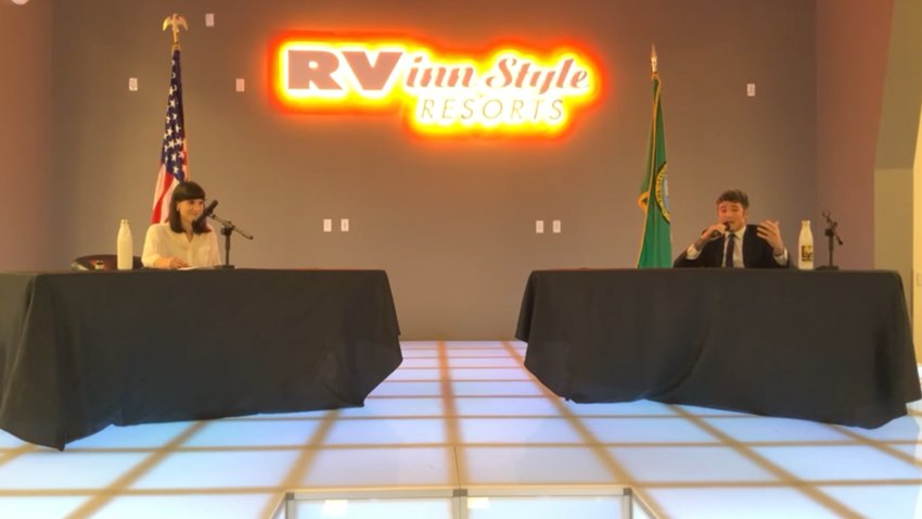 Democrat Marie Glusenkamp Perez, left, and Republican Joe Kent, right, participate in a debate at RV Inn Style Resorts convention center on Sept. 27.