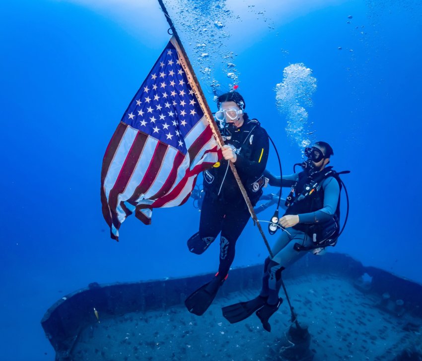 Ashley Bugge carries an American flag as she spreads her husband Brian&rsquo;s ashes into the ocean.