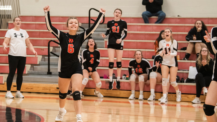 Rainier sophomore Annabelle Whiteman (6) celebrates a point alongside players and coaches on Tuesday.
