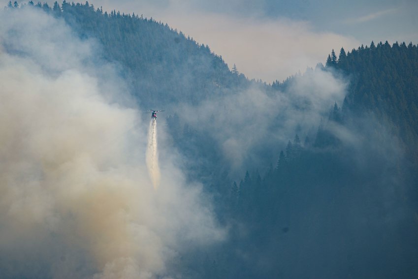 A helicopter drops water on the Goat Rocks Fire Tuesday in this photo provided by the U.S. Forest Service.