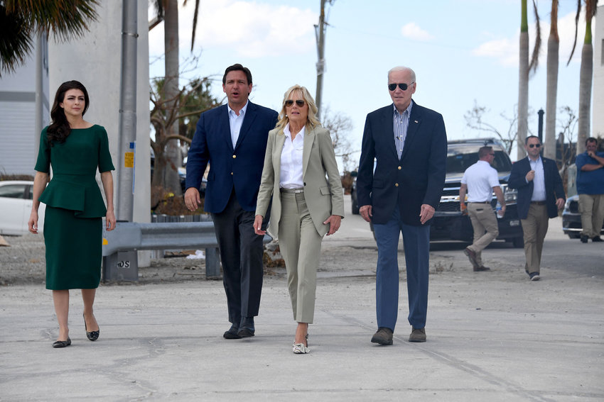 Left to right, Casey DeSantis, Florida Governor Ron DeSantis, US First Lady Jill Biden, and U.S. President Joe Biden walk to meet with local residents impacted by Hurricane Ian at Fishermans Pass in Fort Myers, Florida, on Oct. 5, 2022. (Olivier Douliery/AFP/Getty Images/TNS)