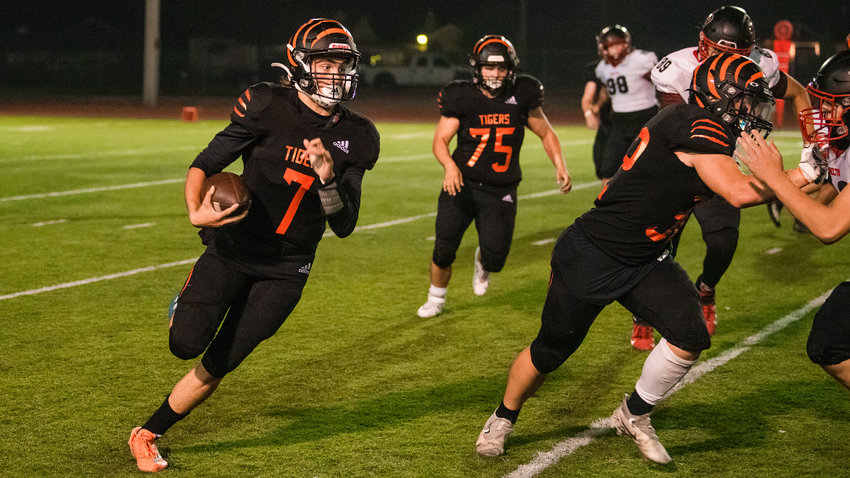 Centralia senior Tommy Billings (7) keeps the football on a run Thursday night during a game against Shelton.