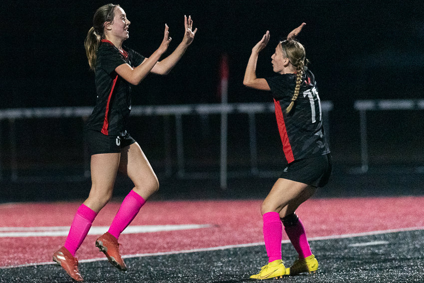 Abagail Archibald (6) celebrates her goal with Elizabeth Disken (11) after scoring Tenino's first goal in its Oct. 6 match on the Black Top against Hoquiam.