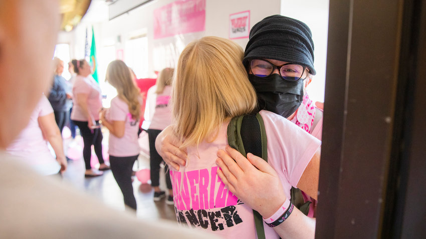 Lori Pulver receives an embrace Friday morning in Chehalis. Pulver has been in an ongoing fight with breast cancer. The phrase &ldquo;Pulver-ize Cancer&rdquo; has been displayed in windows outside the Lewis County Courthouse this month.