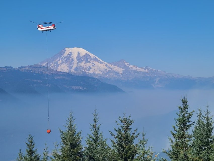 A helicopter drops water on the Goat Rocks Fire near Packwood on Thursday in this photo provided by the U.S. Forest Service.