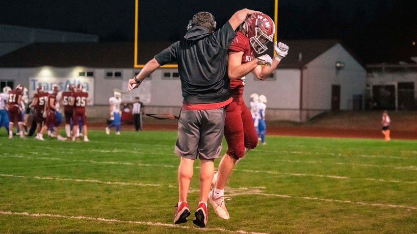 Head Coach Dan Hill celebrates a touchdown with Bearcat sophomore Gage Brumfield (4) in Chehalis on Friday.