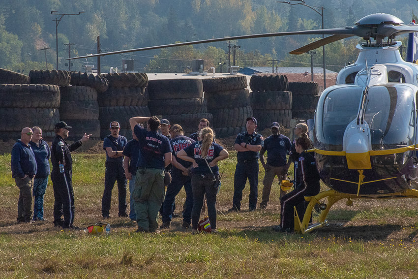 The flight crew from the University of Washington Medicine's transport helicopter goes over mass casualty landing zone procedures with emergency responders from various agencies across Lewis County at the Southwest Washington Fairgrounds for a mass-casualty training event on Saturday.