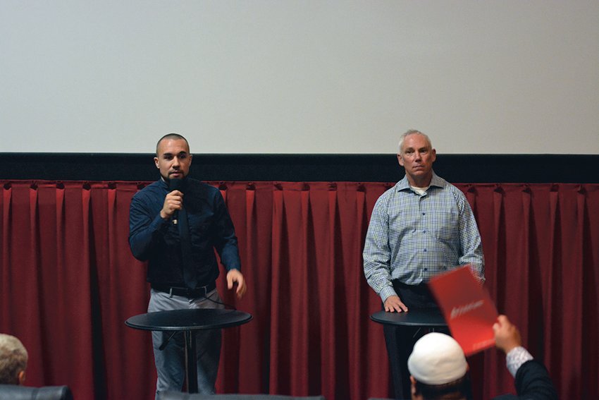 Derek Sanders, left, and John Snaza, right, speak at the &ldquo;meet the candidates&rdquo; town hall at Yelm Cinemas on Oct. 10.