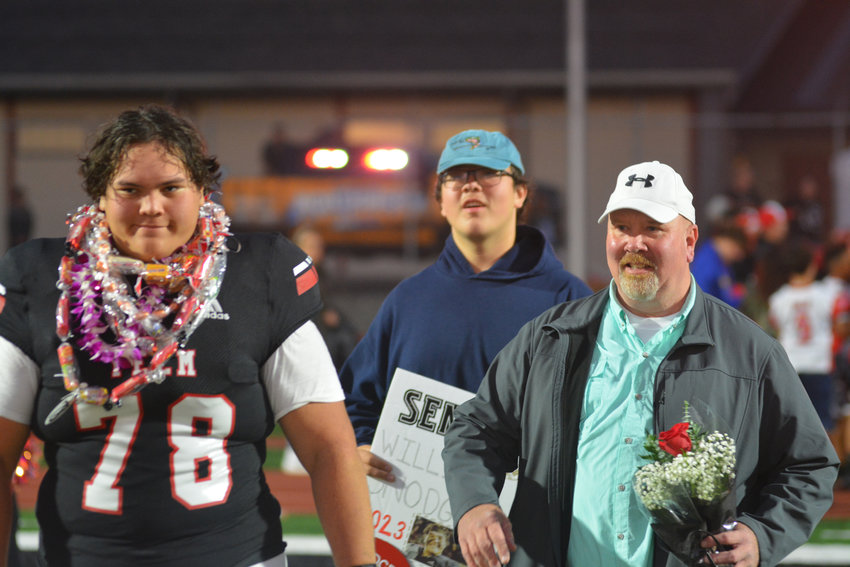 Senior offensive lineman William Snodgrass enters the field with his family behind him on senior night on Oct. 13.