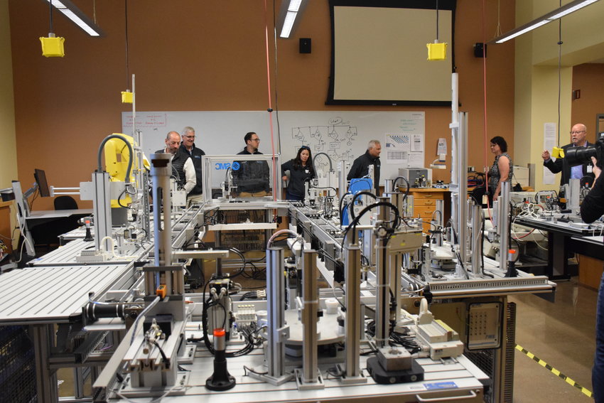 The Association of Washington Business&rsquo; Manufacturing Week bus tour participants look at one of the labs at Clark College&rsquo;s Columbia Tech Center campus on Oct. 10.
