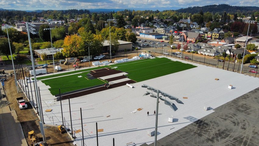 Turf is rolled out onto a multisport athletic field at the Centralia College Campus in September.