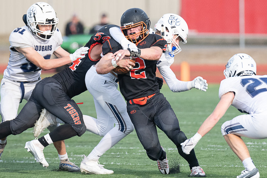Napavine tailback Cael Stanley fights through a tackle against Cascade Christian at Centralia Tiger Stadium Oct. 29.