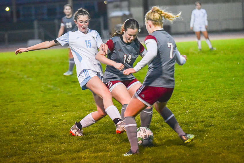 Maddie Shields (14) and Emily Mallonee (7) get stuck in with Hockinson's Oliia Cochenour during W.F. West's 3-1 loss to the Hawks on Nov. 1.