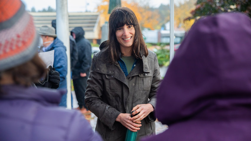 Marie Gluesenkamp Perez smiles while thanking supporters standing in the rain outside the Centralia Timberland Library earlier this month.