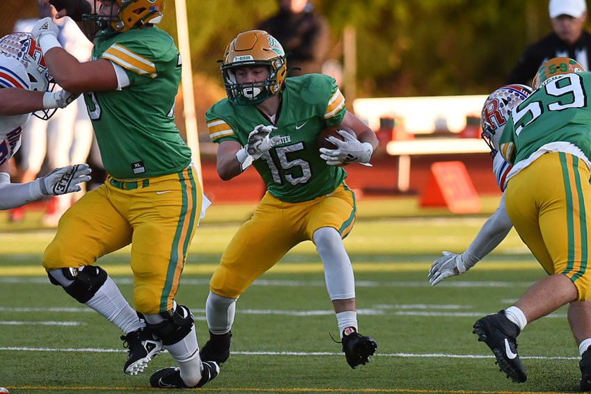 Logan Cole takes the ball during Tumwater's 35-14 crossover win over Ridgefield on Nov. 5.