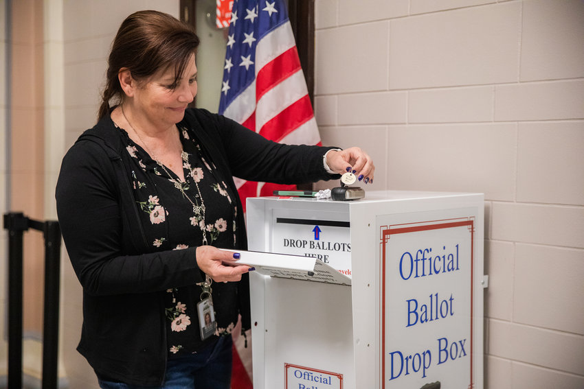 Susan Caldwell prepares to lock up an official ballot box at the Lewis County Courthouse in Chehalis Tuesday night.