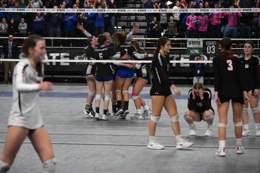 The Oakesdale volleyball team celebrates its state title as Mossyrock walks off the court following the Nighthawks' sweep of the Vikings in the 1B championship game on Nov. 11 in Yakima.