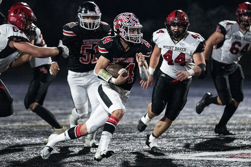 Tenino tailback Triston Whitaker takes a handoff against Mount Baker in the first round of the state playoffs Nov. 11.