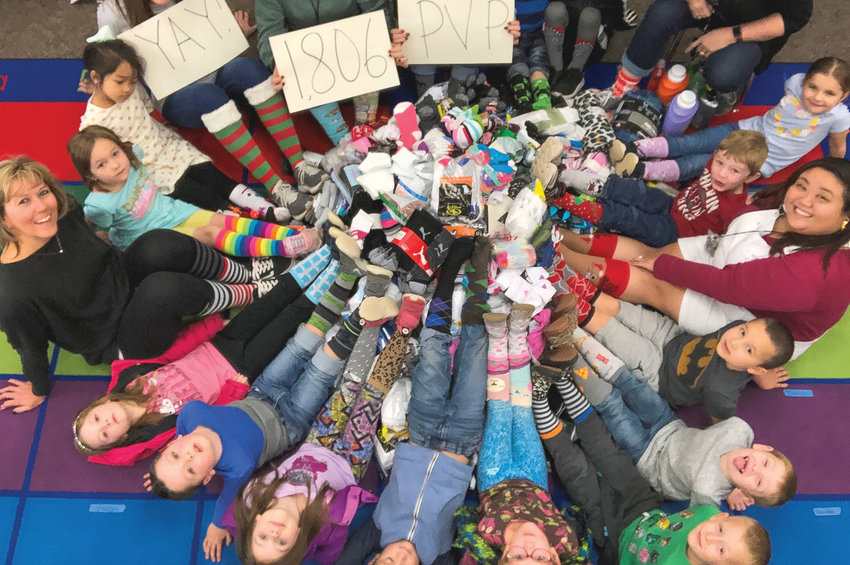 Michelle Anderson&rsquo;s kindergarten class show socks they   donated at a previous Socktober event in 2019.
