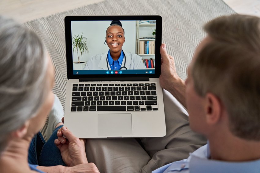 Senior citizens take part in a telehealth appointment with a doctor.