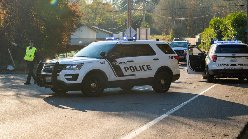 FILE PHOTO&mdash; A Tenino Police officer reroutes traffic to Centralia while law enforcement investigates the scene of an officer involved shooting along Old Highway 99 SE in 2022.